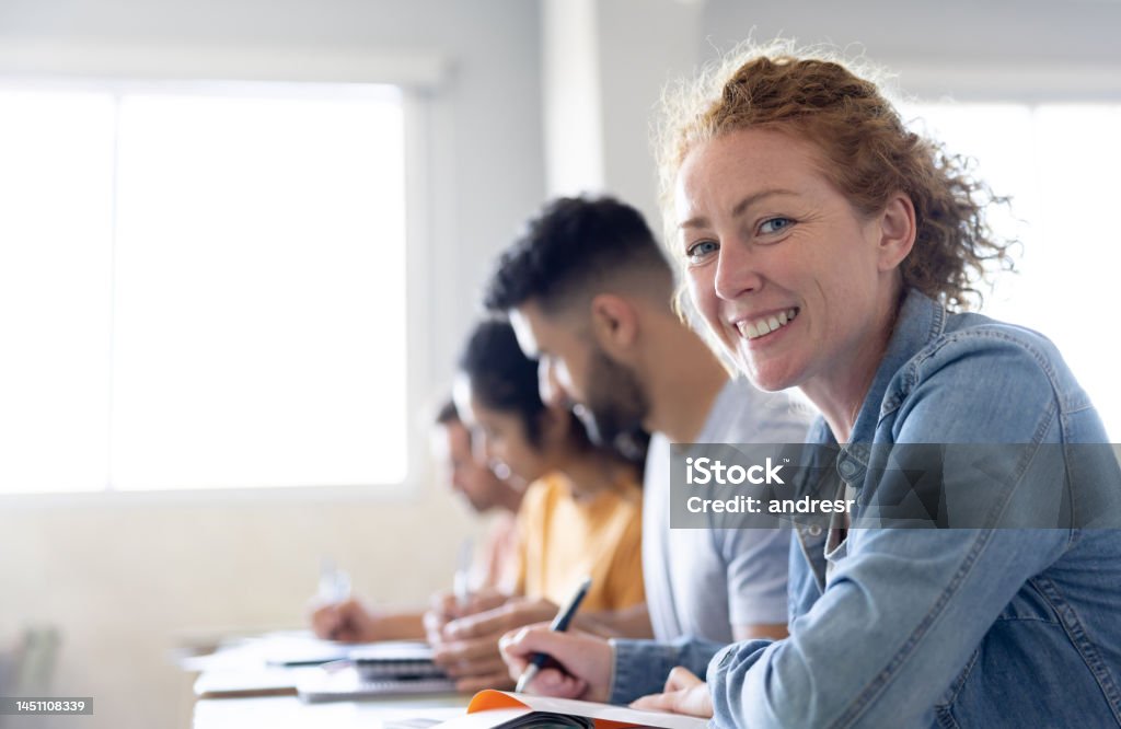 Happy Latin American female college student smiling in class and looking at the camera – education concepts