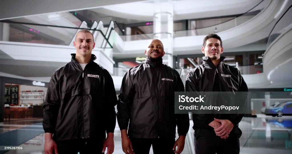Security Officers Stand Guard In The Black Shopping Mall, Protecting Shoppers.